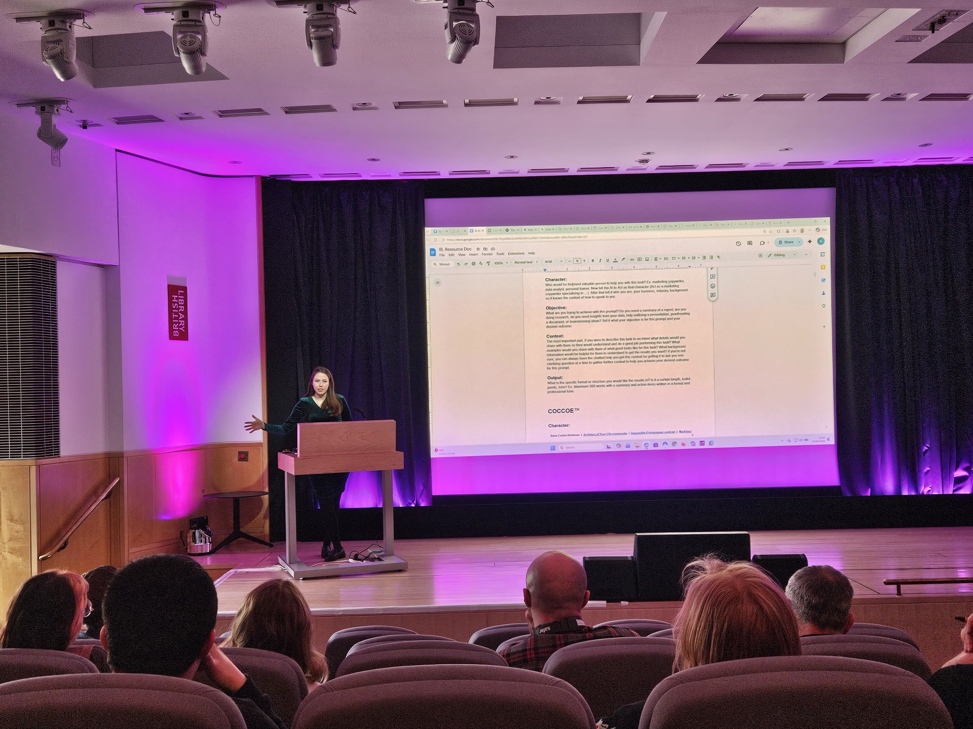 Wide stage shot of Anna Carina Berkman speaking at the British Library