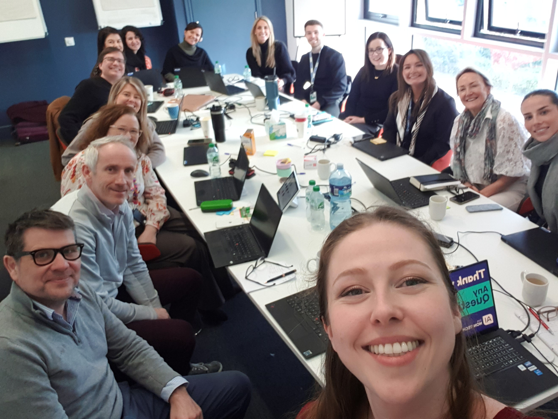 Anna Carina Berkman with an executive workshop cohort around a boardroom table